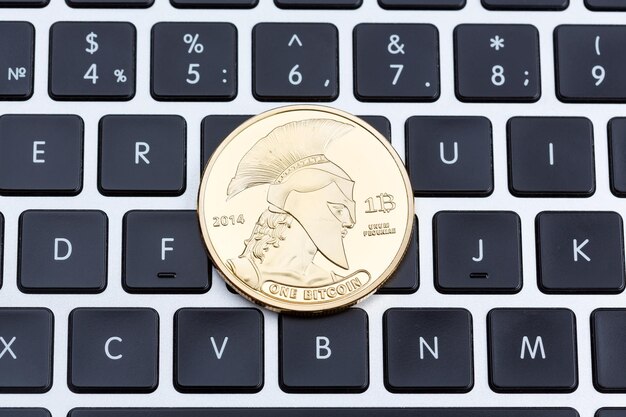 Cryptocurrency physical titan bitcoin coin on black computer keyboard