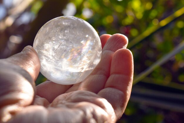 Crystal ball in hand with nature background