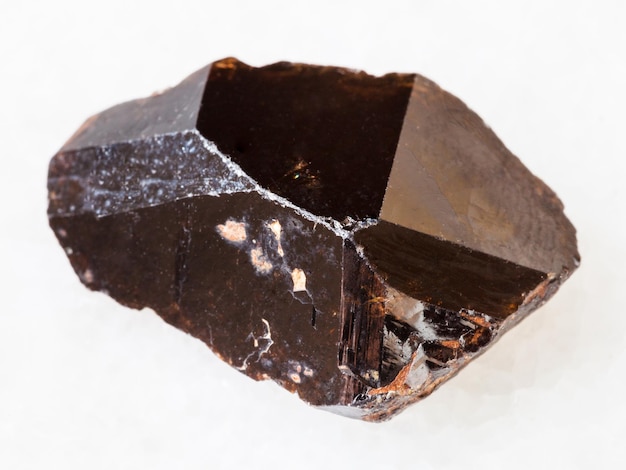 Crystal of Cassiterite stone on white