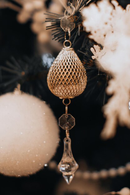 Crystal decoration and white Christmas ball hanging on the Christmas tree Magic details