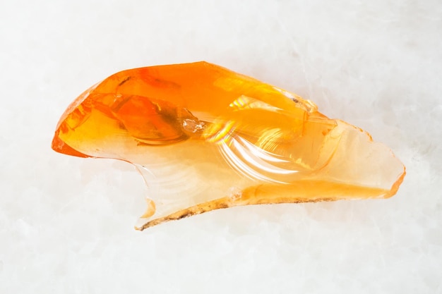 Crystal of fire opal gem on white