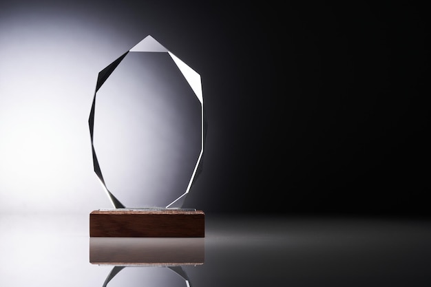 Crystal or glass trophy against gray background