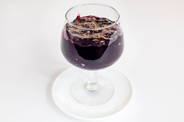 Crystal glass with chicha morada and cinnamon on top