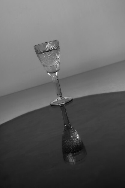 Crystal glass with clear liquid in tilted black and white photo Simple lines Picture for a bar