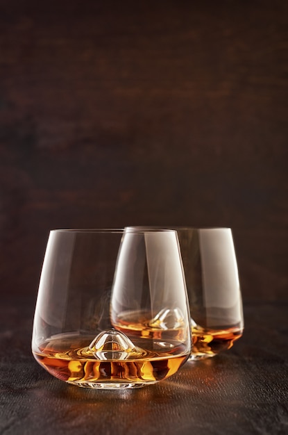 Crystal glass with whiskey on a wooden table