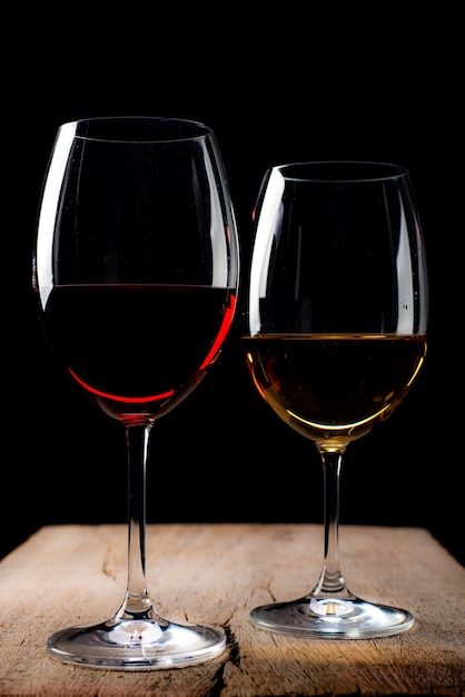 Crystal glasses with red and white wineover rustic wooden table