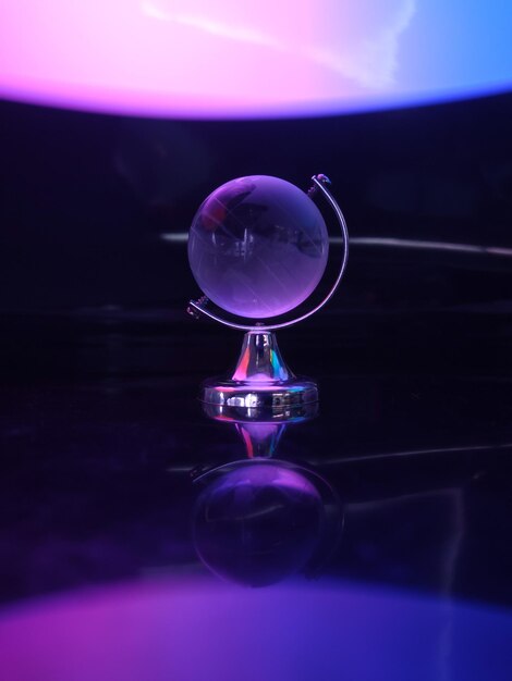 Crystal globe on a black background with reflection