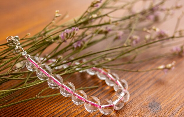 Crystal quartz bracelet close up and flowers