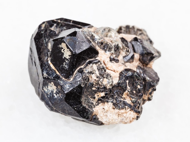 Crystal of Spinel gemstone on black Diopside