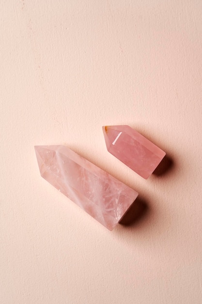 Crystal stone on pink background with copy space top view Mineral stone