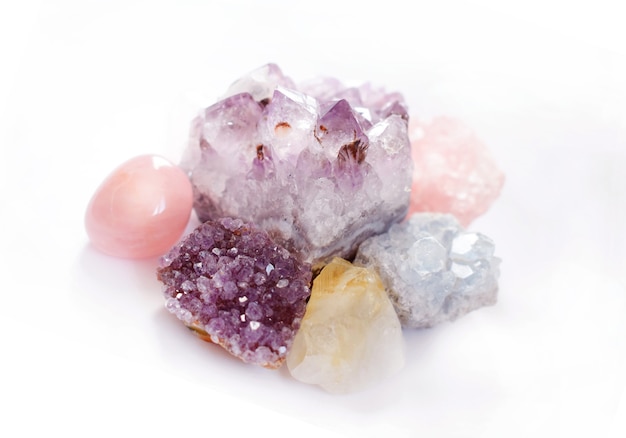 Crystals of amethyst and rose quartz. Gems on a white background. Magic stones.