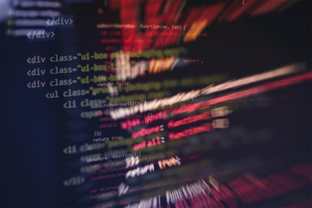CSS、JavaScript、およびHTMLの使用法。関数のソースコードのクローズアップを監視します。抽象的なIT技術の背景。ソフトウェアのソースコード。