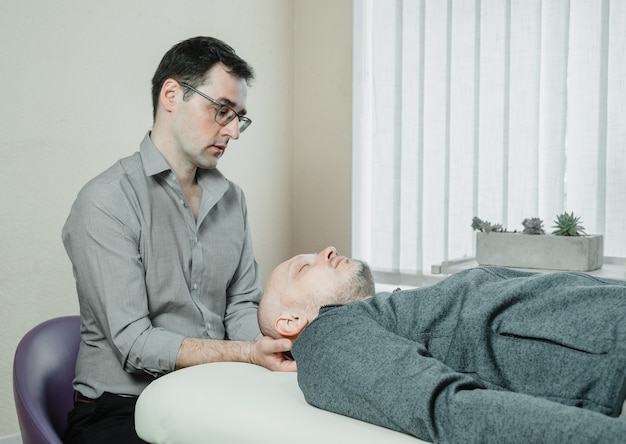 Cst practitioner uses gentle pressure to relieve the stress and pain caused by compression