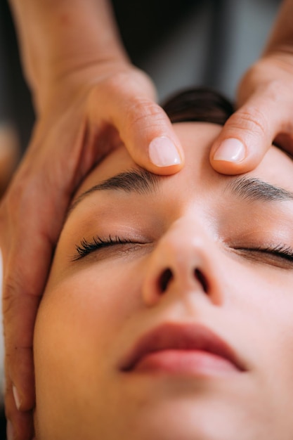 Cst therapist massaging woman's head craniosacral therapy massage