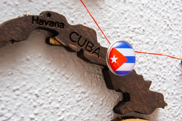 Cuba flag on the pin with red thread showed the paths on the wooden map