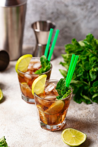 Cuba libre cocktail with mint and lime