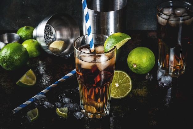 Cuba Libre, long island or iced tea cocktail with strong alcohol, cola, lime and ice, two glass