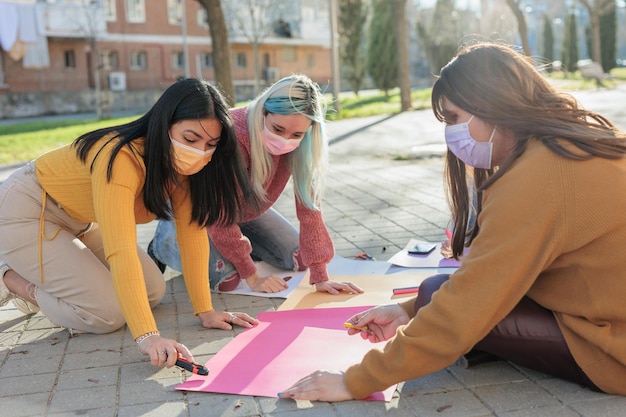 Cuban ecuadorian hispanic and mexican women doing banners for feminism protest women power in international womens day 8 march