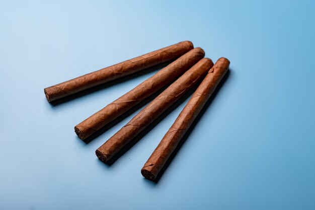 Cuban handmade cigars on a blue background.