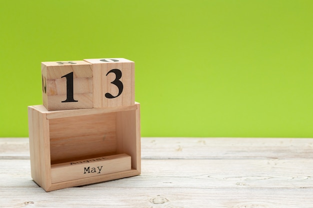 cube calendar for may 13th on wood with copy space