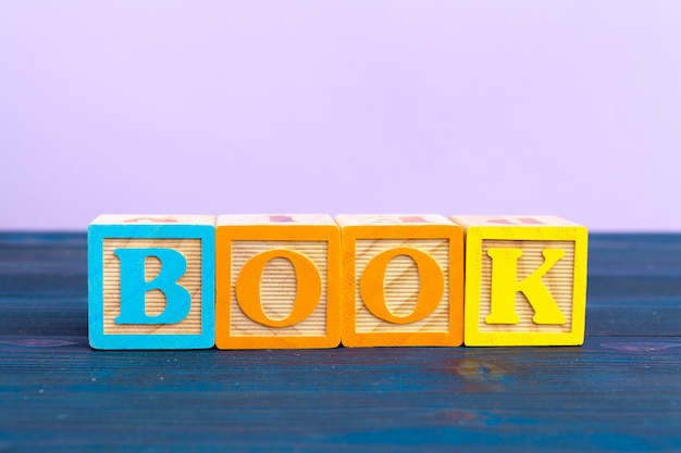 Cube wooden block with alphabet building the word book