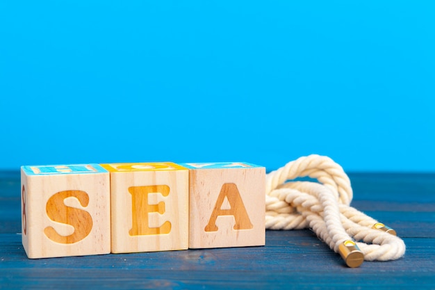 Photo cube wooden block with alphabet building the word sea