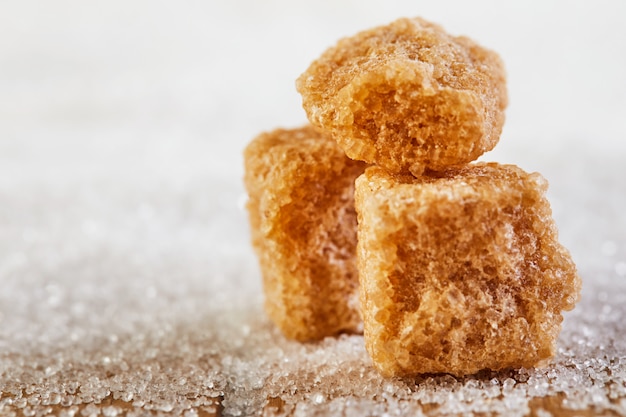 Cubes of brown sugar on white sugar