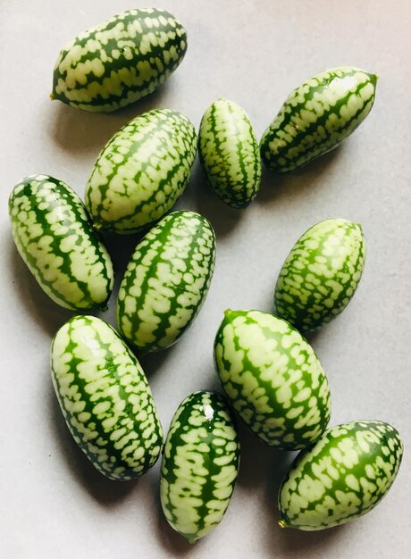 Cucamelons freshly picked and placed on a white background with a high angled view