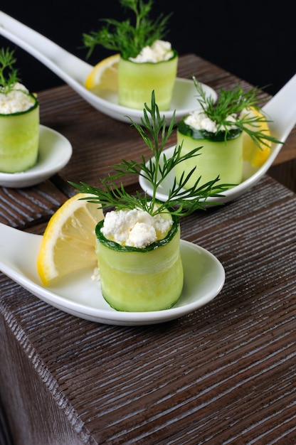 Photo cucumber canape with ricotta and lemon slice closeup