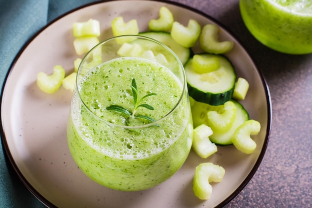 Cucumber and celery smoothie for vegetarian antioxidant diet in glass on table