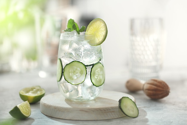 Cucumber cocktail lemonade with lime on the table