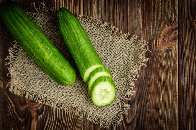 Cucumber on dark wooden space.