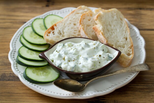 Cucumber dip with bread on plate