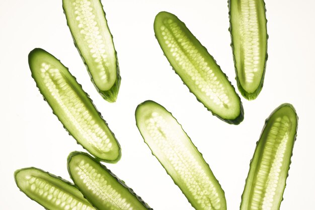 Cucumber green slices pattern isolated on white background.\
creative cucumbers wallpaper, food backdrop design