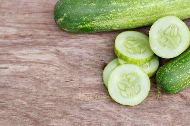 Cucumber isolated on wood background.