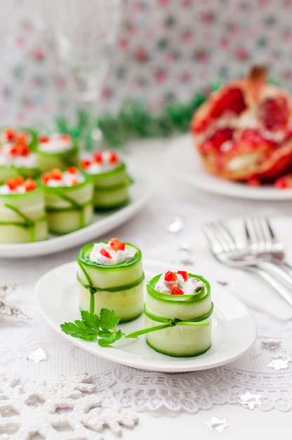 Cucumber rolls stuffed with feta cheese, herbs, capsicum and black olives