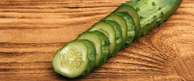 Cucumber sliced lies on a wooden table.