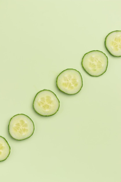Cucumber slices on a green background