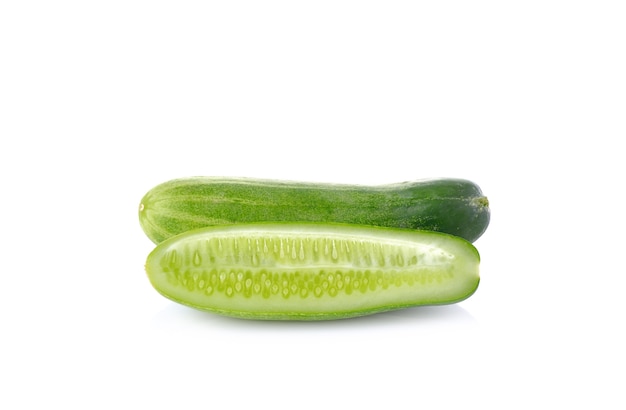 Cucumber and slices on white wall