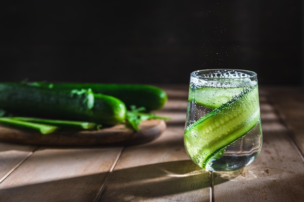 Cucumber soft summer drink on a dark background