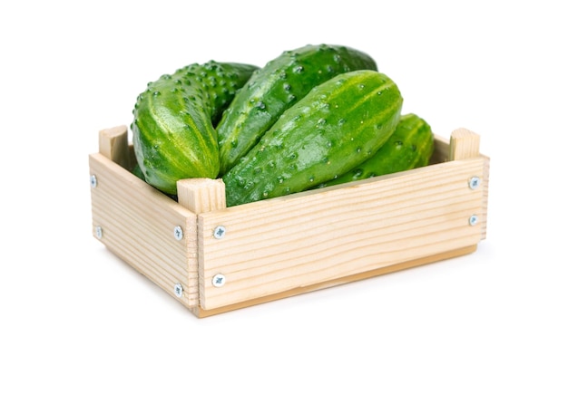 Cucumbers in a wooden box isolated on white background