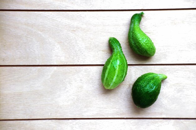 cucumbers on a wooden table three ugly mini cucumbers harvesting concept vegetarian meal selective focus