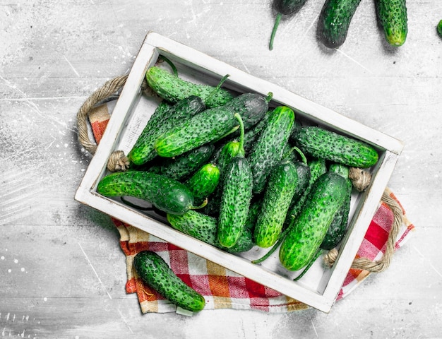 Cucumbers on a wooden tray with a napkin