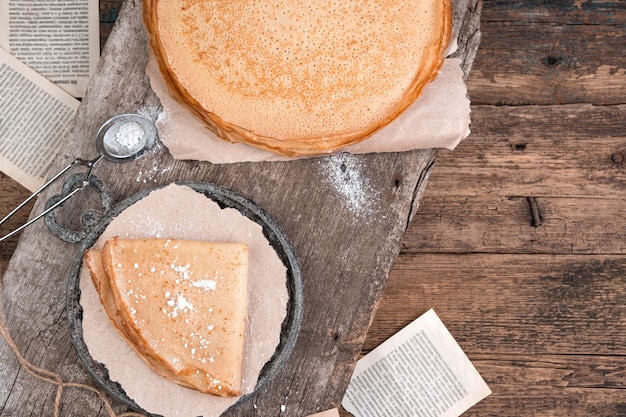 Culinaire achtergrond met pannenkoeken op vintage planken.