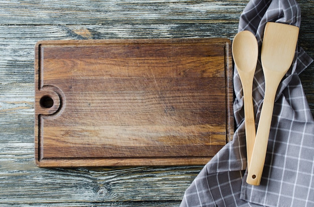 Culinary background with rustic kitchenware on vintage wooden table.