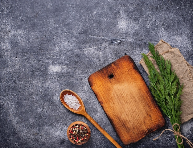 Culinary background with spices and cutting board 