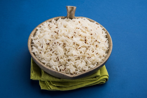 Cumin rice or Indian Jeera Rice on colourful background, selective focus