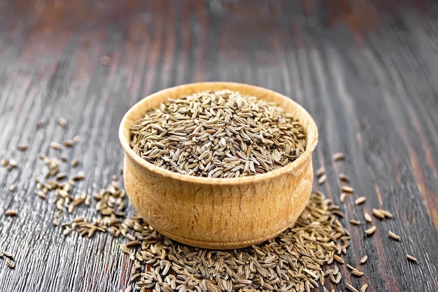 Cumin seeds in bowl on board