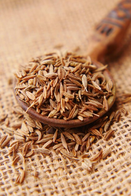 cumin seeds on spoon on table  close up