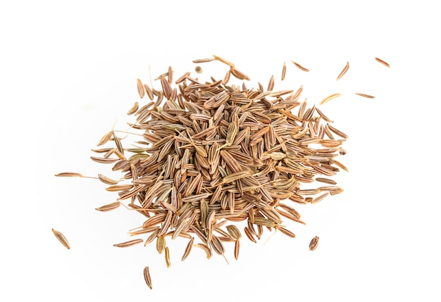 Cumin seeds on white surface